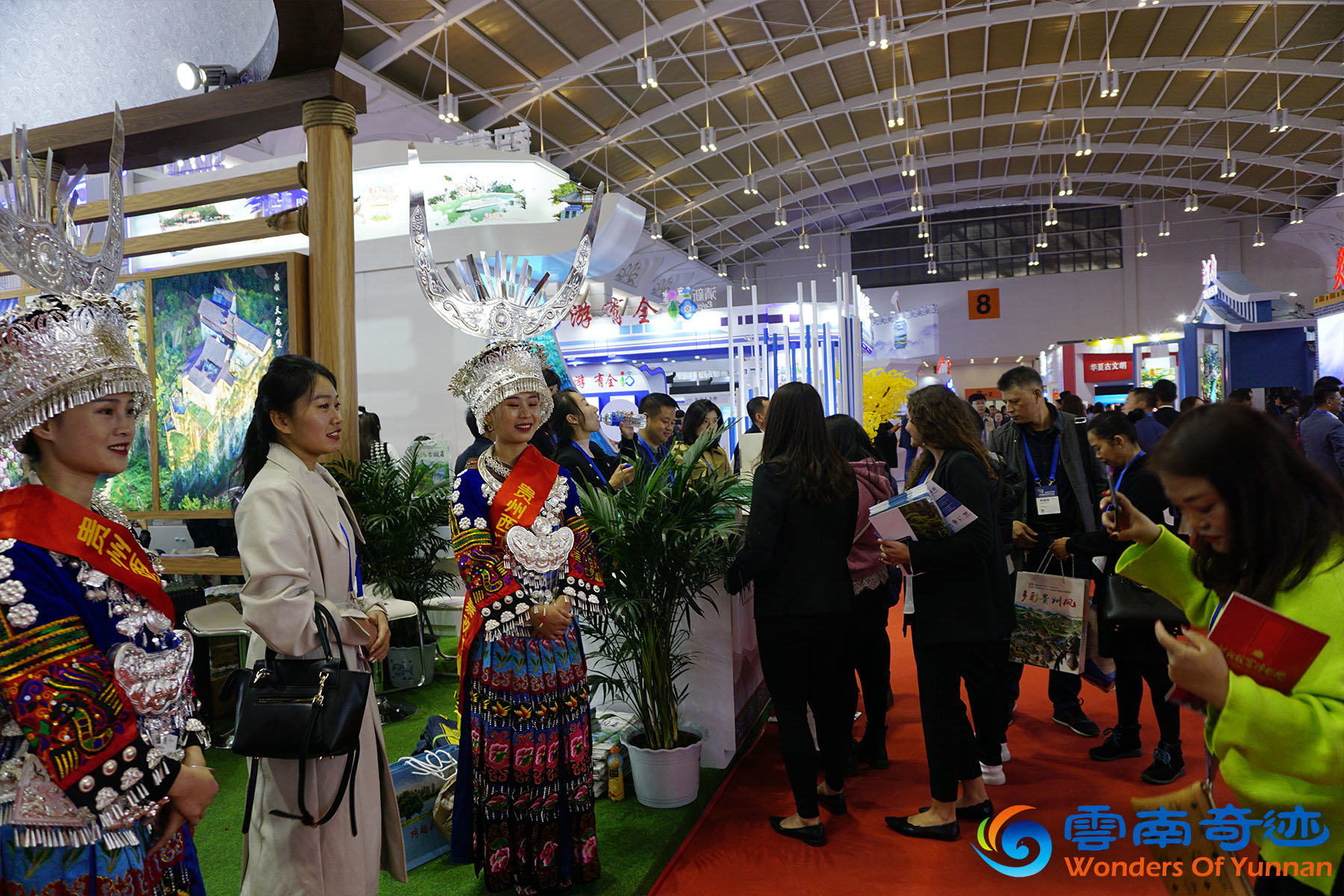 CITM China International Travel Mart 2019 Wonders of Yunnan Amazing Guizhou government booth with Miao ethnic minority girls welcoming visitors