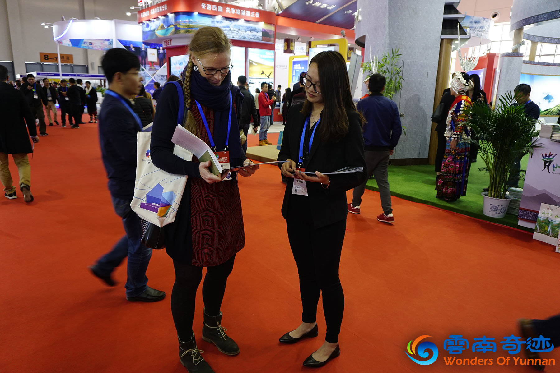 CITM China International Travel Mart 2019 Wonders of Yunnan Amazing Guizhou staff talking to foreign visitor