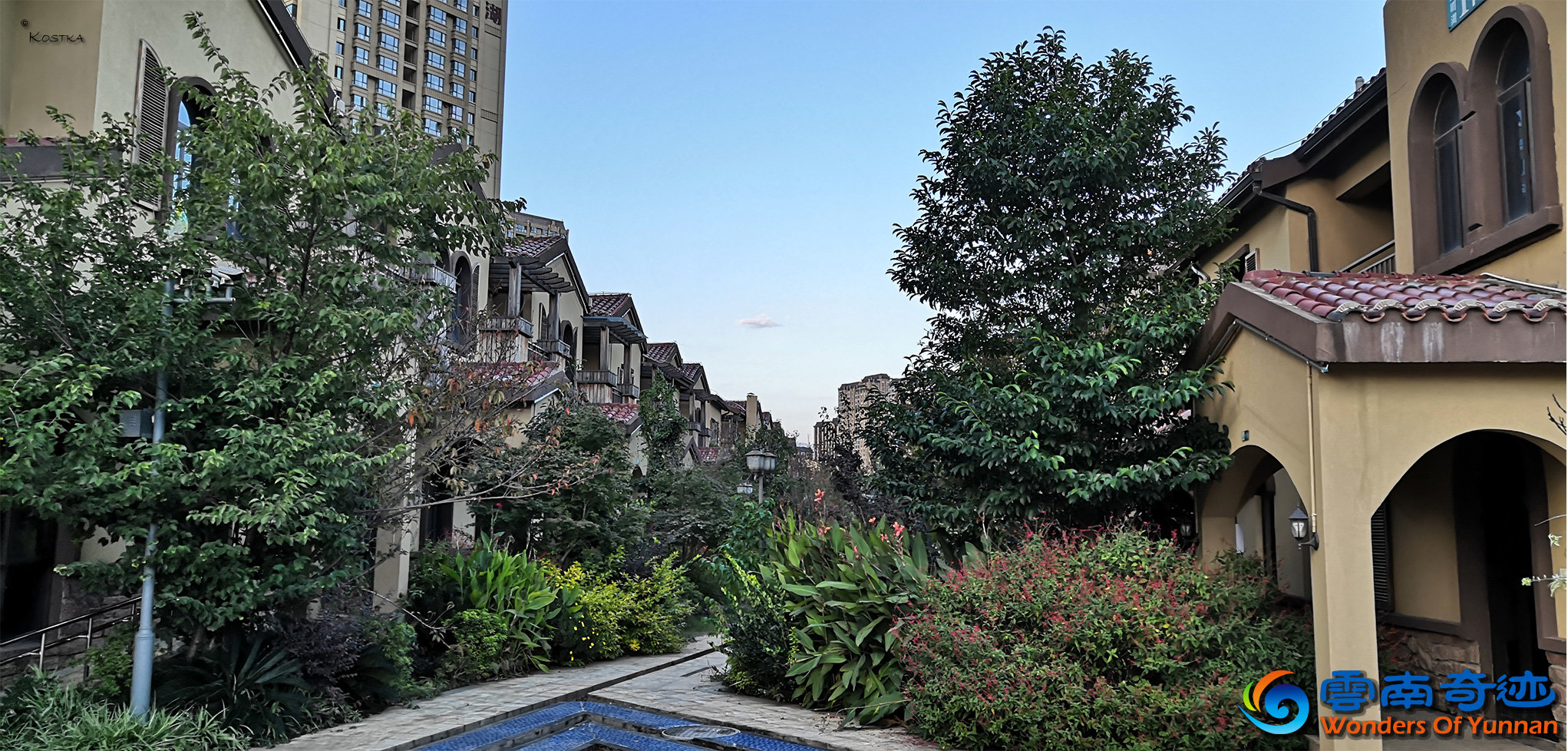 Behind the buildings of Pan Jiang Xi Lu with beautiful gardens covered with flowers, trees and plants