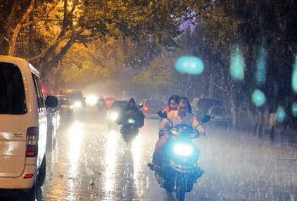 scooters driving in heavy rain storm in kunming yunnan china