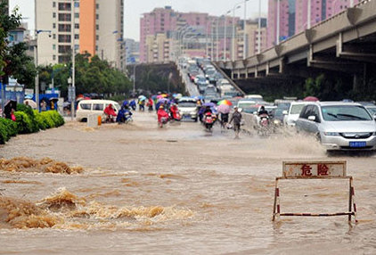 cars and scooters driving on flooded highway kunming yunnan china