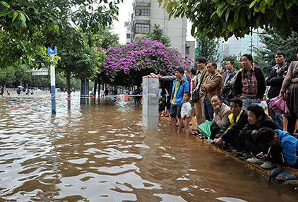 pedestrians stuck on a flooded street after rain in kunming yunnan china