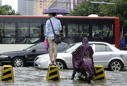 cars and people stuck in traffic jam during summer rain in kunming yunnan china