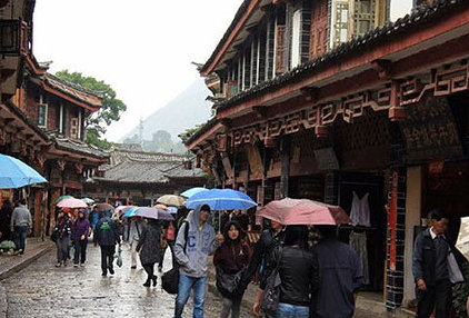 people with umbrellas during rain in lijiang old town yunnan china