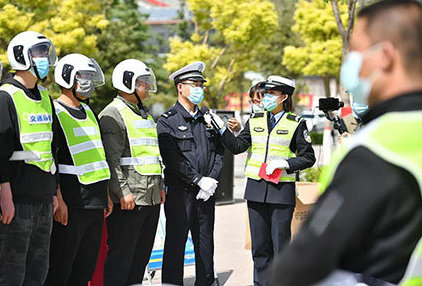 chinese police enforcing law wear helmet on the scooter