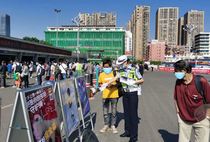 Chinese police enforcing law wear helmet on the scooter at Kunming train station