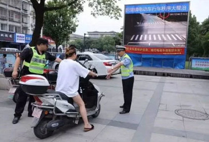 Chinese police enforcing law wear helmet on the scooter 