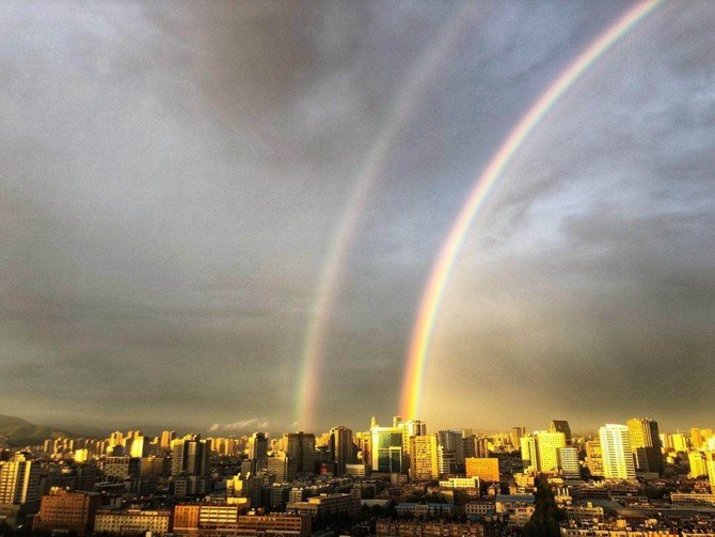 double rainbow with dark clouds above kunming yunnan china