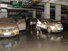 cars covered in mud in underground car park after flooding was cleared kunming yunnan china